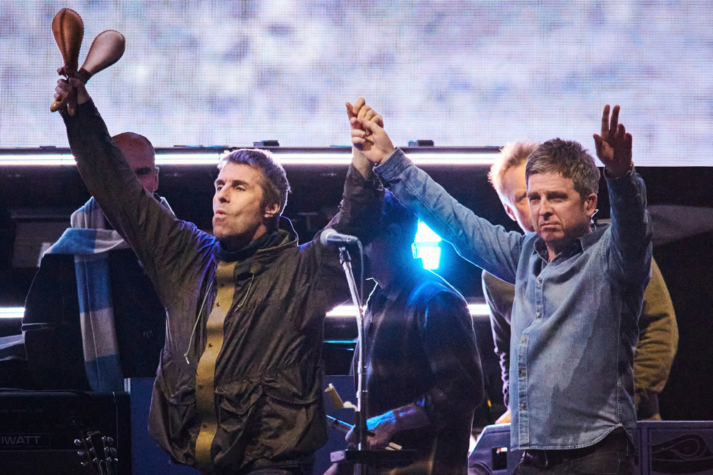 FILE - Liam Gallagher, left, and Noel Gallagher of Oasis walk onstage together during their reunion tour in Toronto, Sunday, Aug. 24, 2025. (Sammy Kogan/The Canadian Press via AP, File)