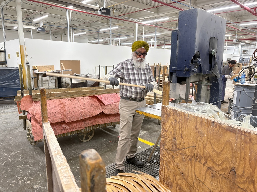 A worker makes wooden hockey sticks at the Roustan Hockey factory, which is the last major manufacturer of hockey sticks in Canada on Aug. 27, 2025 in Brantford, Ontario. (AP Photo/Kelvin Chan)