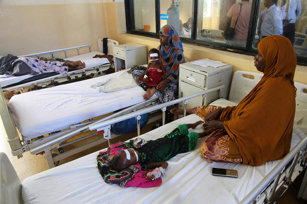 FILE - Women sit with malnourished children at Banadir Hospital in Mogadishu, Somalia, May 14, 2025. (AP Photo/Farah Abdi Warsameh, File)