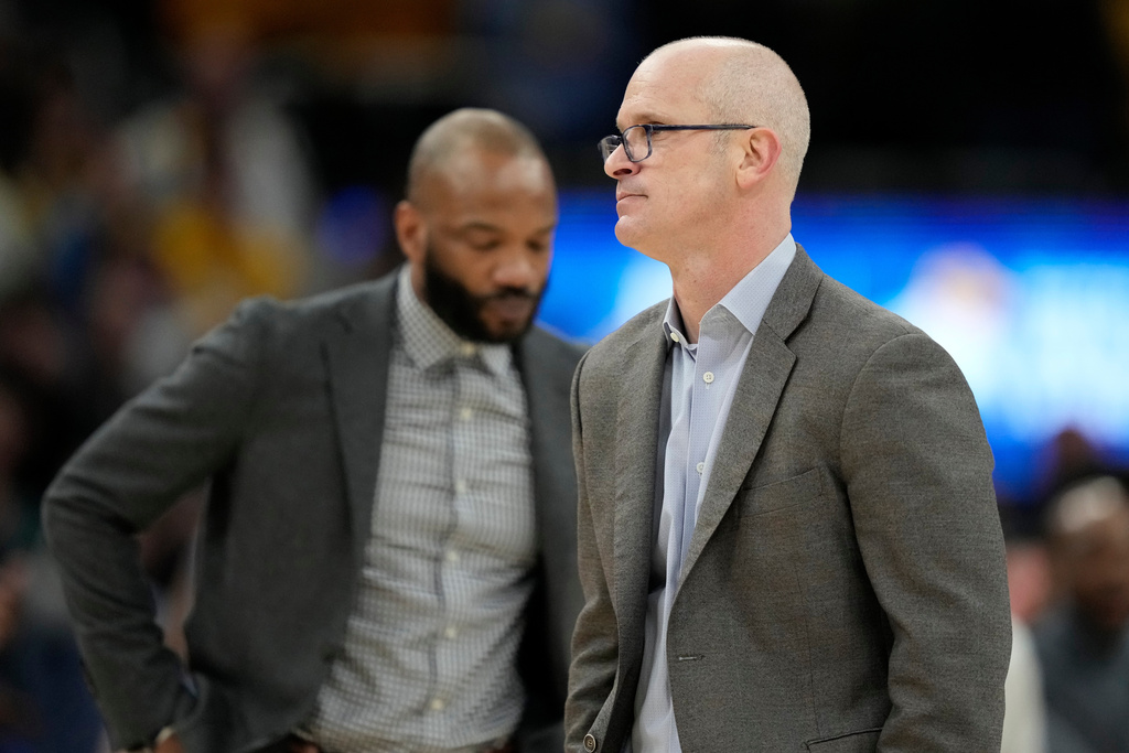 UConn head coach Dan Hurley, right, exits the court after being ejected during an NCAA college basketball game against Marquette, Saturday, March 7, 2026, in Milwaukee. (AP Photo/Aaron Gash)