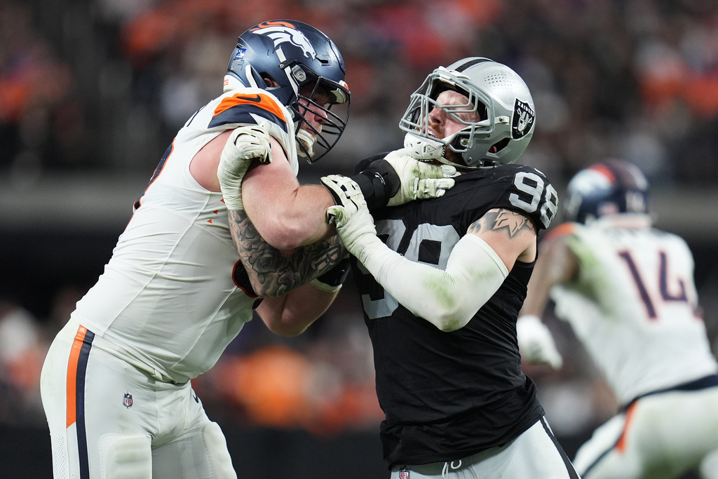 Denver Broncos offensive tackle Garett Bolles, left, blocks Las Vegas Raiders defensive end Maxx Crosby during the second half of an NFL football game in Las Vegas, Sunday, Dec. 7, 2025. (AP Photo/Gregory Bull)