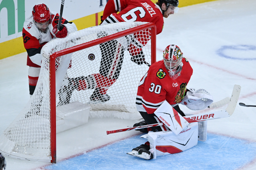 Chicago Blackhawks goalie Spencer Knight misses a goal scored by Carolina Hurricanes' Jackson Blake during the second period of an NHL hockey game Saturday, Oct. 10, 2026, in Chicago. (AP Photo/Paul Beaty)