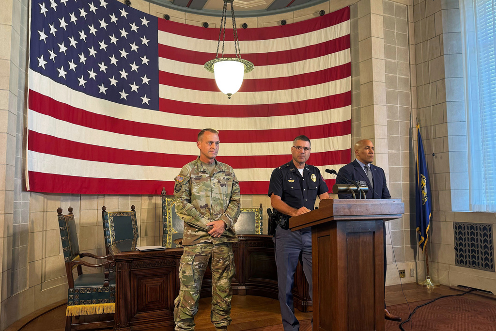 Nebraska State Patrol Superintendent Colonel Bryan Waugh, center, flanked by National Guard Adjutant General Maj. Gen. Craig W. Strong, left, and Department of Correctional Services Director Rob Jeffreys, speaks about plans for a new immigration detention center and an agreement to allow state troopers to enforce immigration laws at a news conference at the Nebraska State Capitol in Lincoln, Neb., Tuesday, Aug. 19, 2025. (AP Photo/Josh Funk)