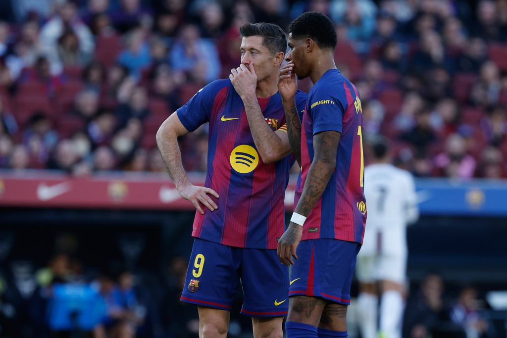 Barcelona's Robert Lewandowski, left, and Marcus Rashford talk during the Spanish La Liga soccer match between Barcelona and Mallorca in Barcelona, Spain, Saturday, Feb. 7, 2026. (AP Photo/Joan Monfort)