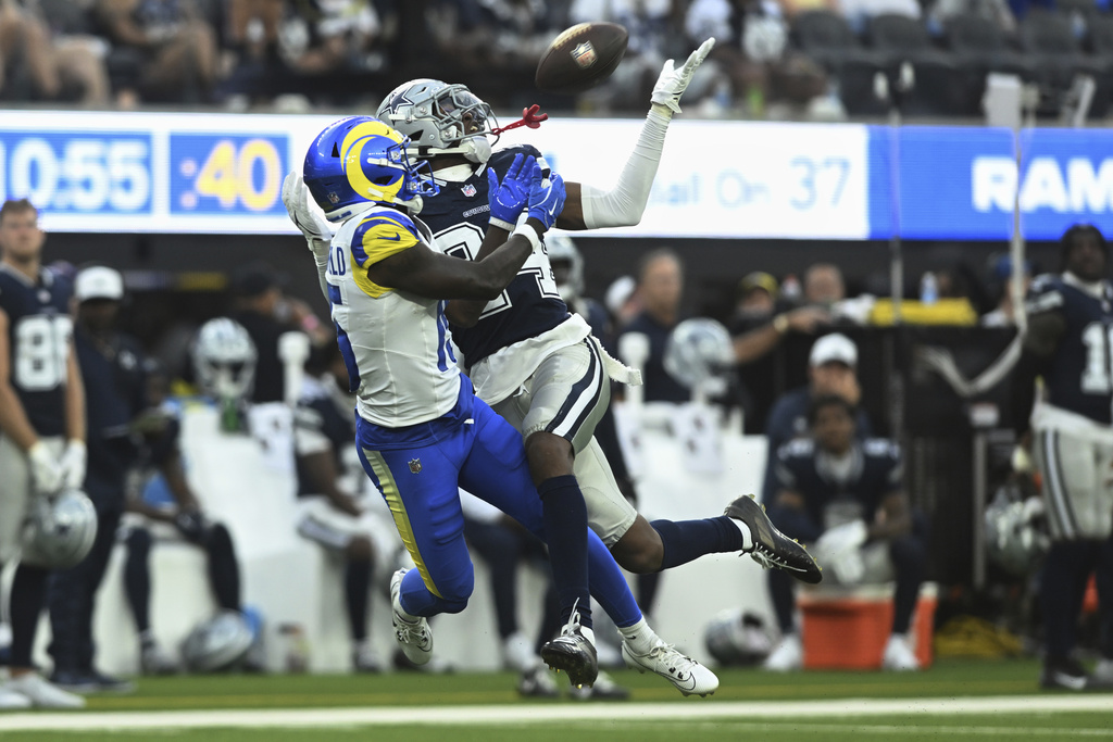 Dallas Cowboys safety Israel Mukuamu (24) intercepts a pass intended for Los Angeles Rams wide receiver Konata Mumpfield (15) during the second half of an NFL preseason football game, Saturday, Aug. 9, 2025, in Inglewood, Calif. (AP Photo/Wally Skalij)
