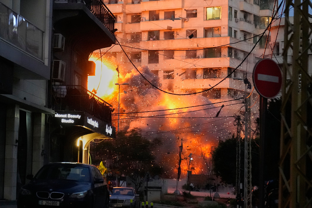 An explosion erupts from a building following an Israeli strike in central Beirut, Lebanon, Wednesday, March 18, 2026. (AP Photo/Hussein Malla)