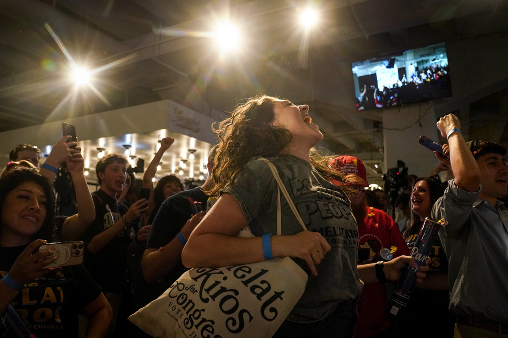 Nikita Valdez jumps while cheering after the first report of the election results show Democratic congressional candidate Melat Kiros in the lead during a primary election night watch party at The Broadway, Tuesday, June 30, 2026, in Denver. (AP Photo/Rebecca Slezak)