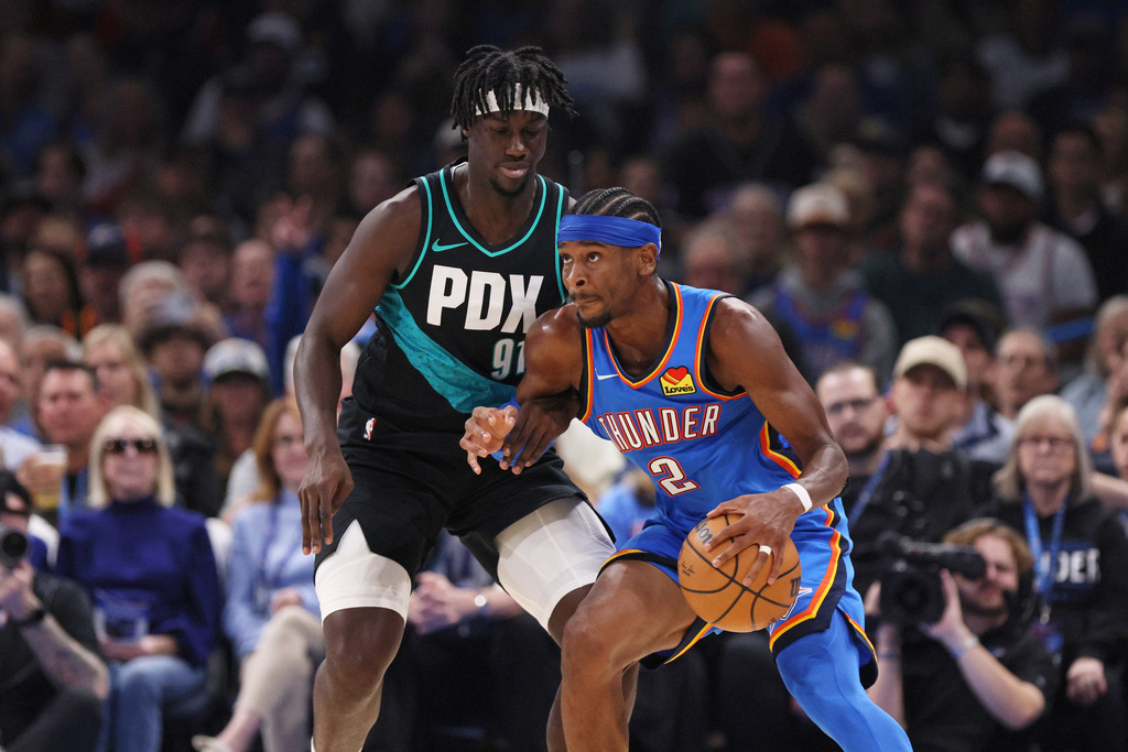 Oklahoma City Thunder guard Shai Gilgeous-Alexander (2) handles the ball against Portland Trail Blazers guard Sidy Cissoko (91) during the first half of an NBA basketball game Sunday, Nov. 23, 2025, in Oklahoma City. (AP Photo/Nate Billings)