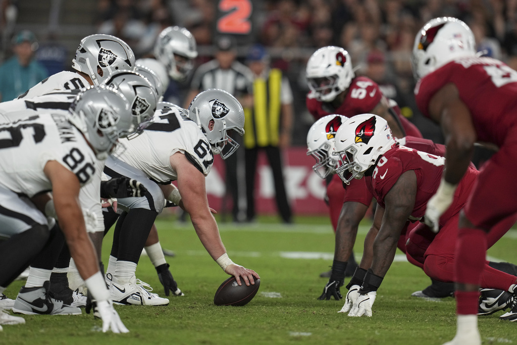 The Las Vegas Raiders and the Arizona Cardinals line up during the first half of an NFL preseason football game, Saturday, Aug. 23, 2025, in Glendale. (AP Photo/Rick Scuteri)