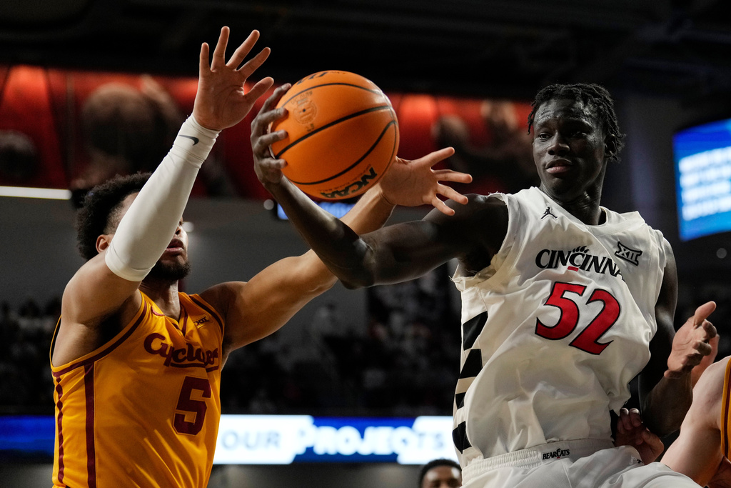 Iowa State Cyclones Joshua Jefferson (5) and Cincinnati center Moustapha Thiam (52) battle for a rebound during the first half of an NCAA college basketball game, Saturday, Jan. 17, 2026, in Cincinnati. (AP Photo/Carolyn Kaster)
