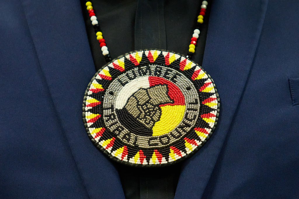 Wearing a traditional bolo that says "Lumbee Tribal Council," a member of the Lumbee Tribe of North Carolina, attends a celebration after the passage of a bill granting the tribe with federal recognition, on Capitol Hill, in Washington, Wednesday, Dec. 17, 2025. (AP Photo/Jacquelyn Martin)
