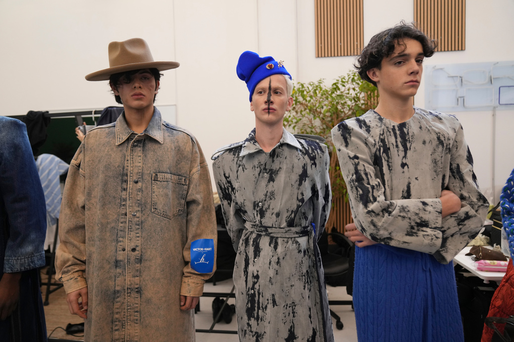 Models get ready in the backstage of the Victor Hart Fall/Winter 2026-2027 Men's fashion show presented in Milan, Italy, Jan. 18, 2026. (AP Photo/Antonio Calanni)
