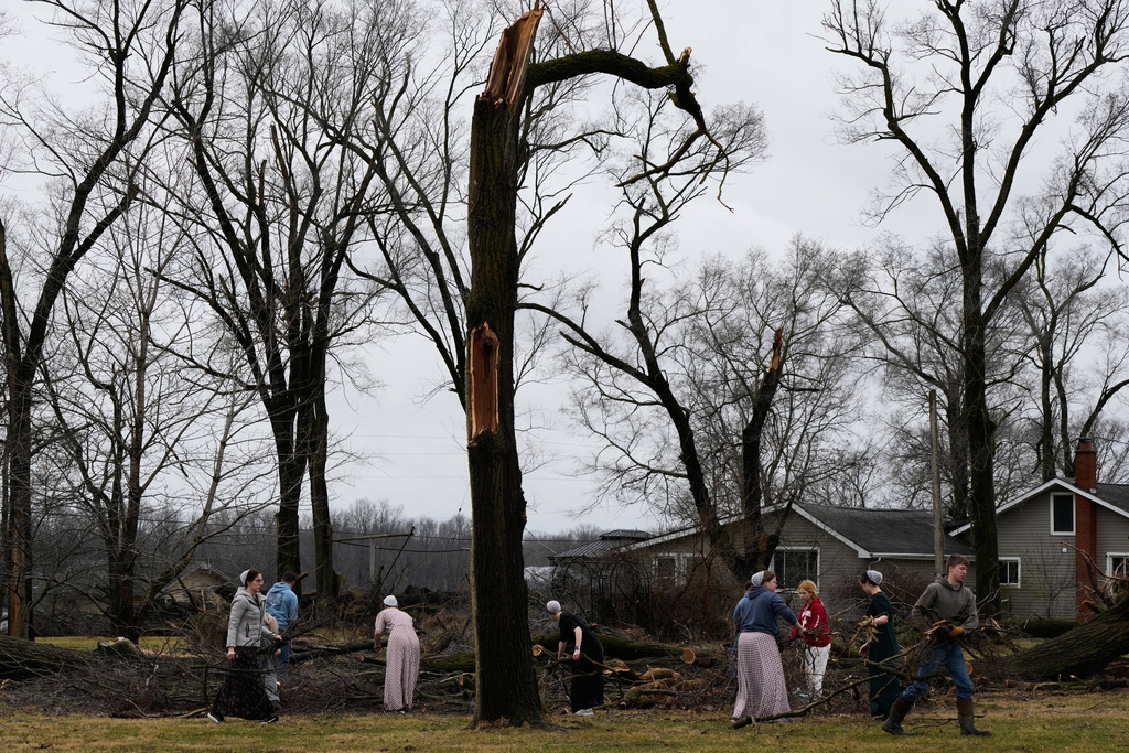 Volunteers clear debris after a suspected tornado hit the area a day earlier, in Union City Mich., Saturday, March 7, 2026. (AP Photo/Nam Y. Huh)