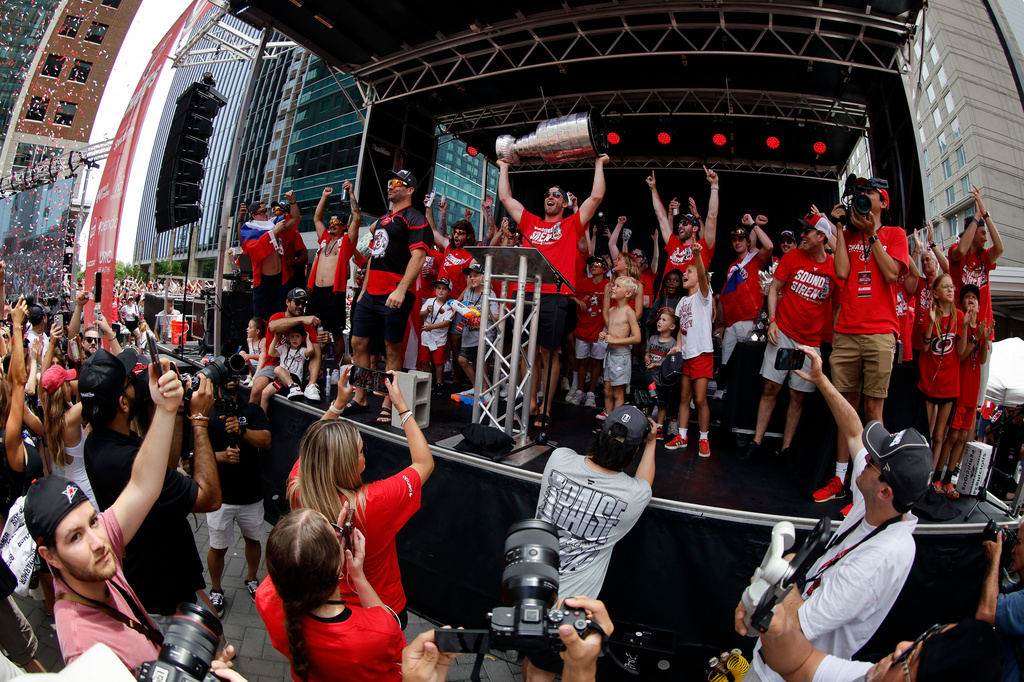 FILE - Carolina Hurricanes lead the crowd in a final storm surge with Jordan Staal (11) holding the Stanley Cup during Stanley Cup Celebration in Raleigh, N.C., June 20, 2026. (AP Photo/Karl DeBlaker, File)