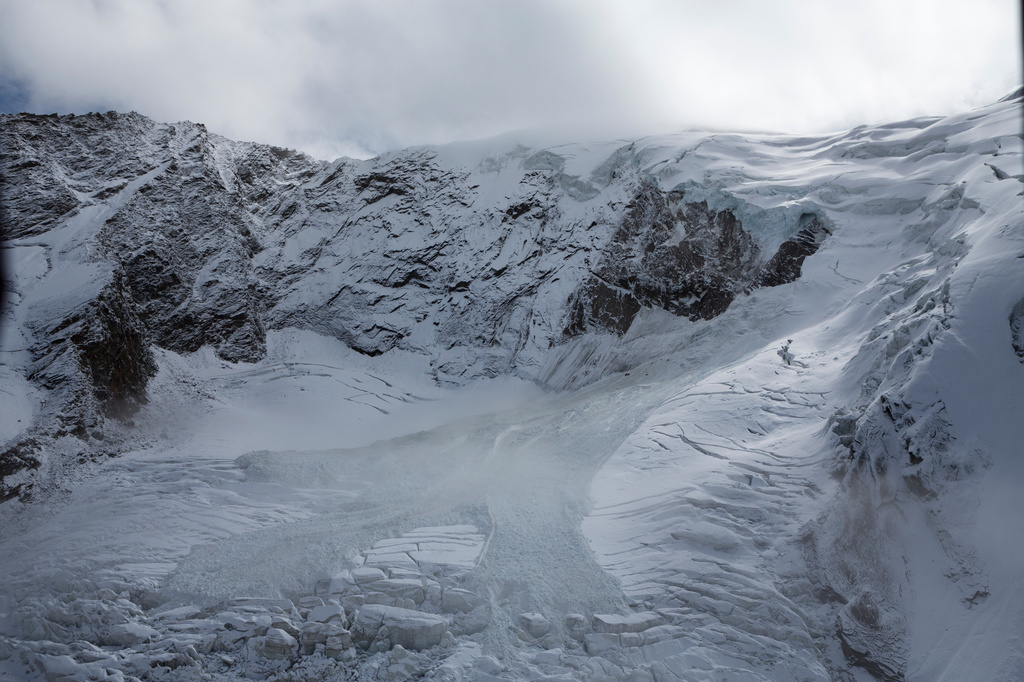FILE - The glacial ice avalanche of the Trift Glacier above the village in Saas-Grund, Valais, Switzerland, Sunday, Sept. 10, 2017. (Dominic Steinmann/Keystone via AP, File)