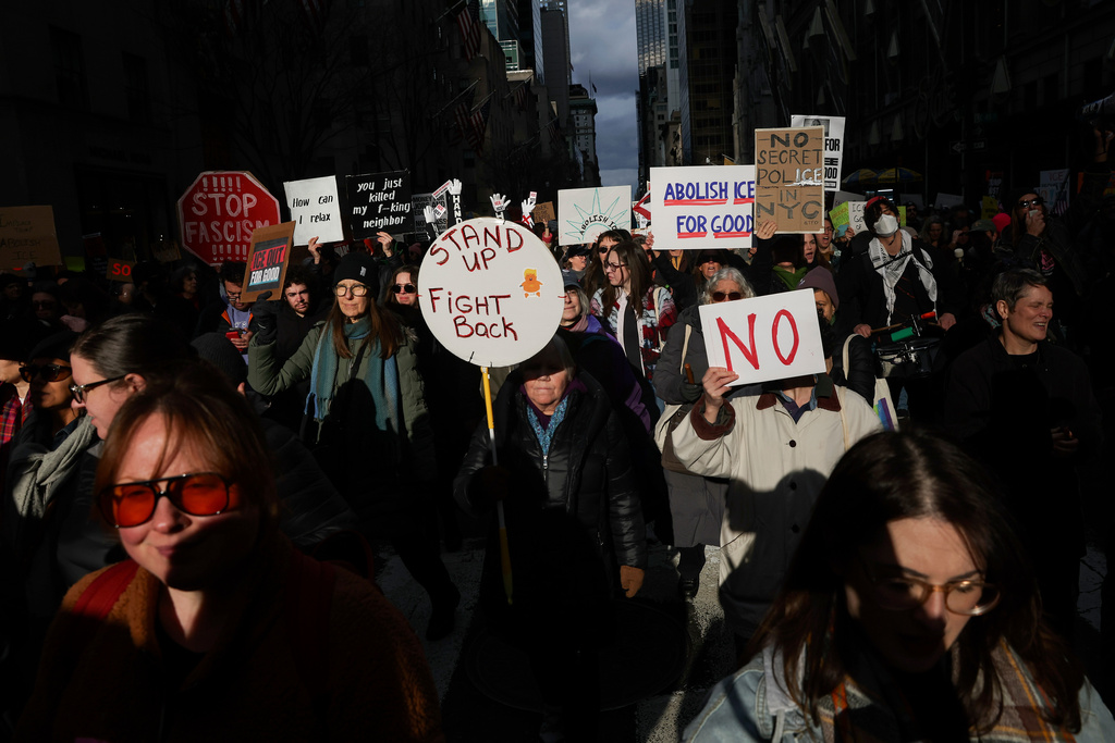 Demonstrators march down Fifth Avenue during a protest against war in Venezuela and Immigration and Customs Enforcement, Sunday, Jan. 11, 2026, in New York. (AP Photo/Heather Khalifa)