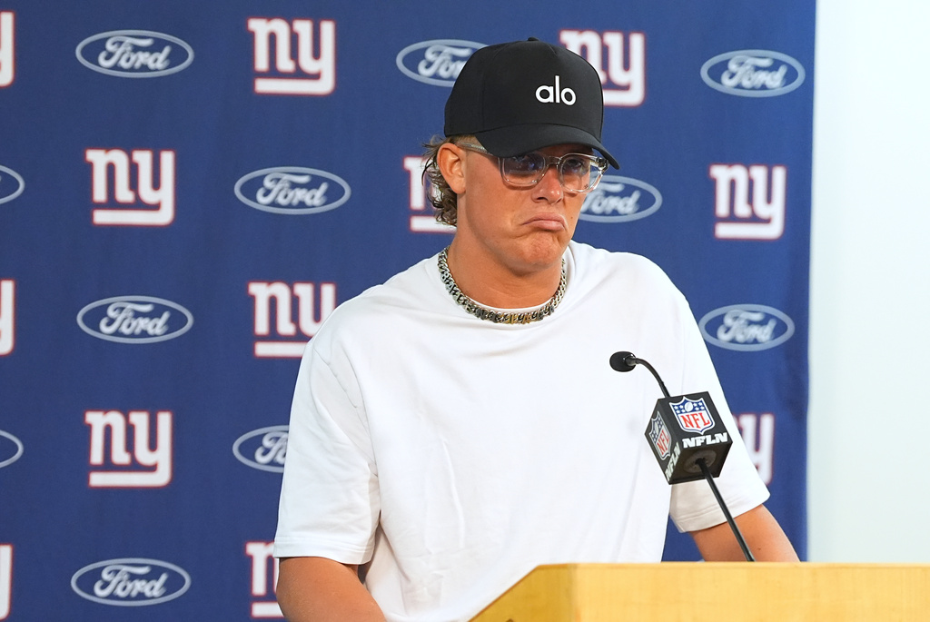 New York Giants quarterback Jaxson Dart responds to questions after an NFL football game against the Denver Broncos, Sunday, Oct. 19, 2025, in Denver. (AP Photo/David Zalubowski)