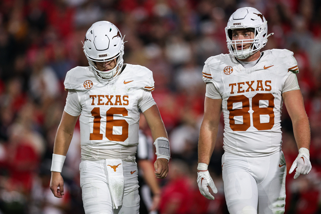 Texas quarterback Arch Manning (16) and tight end Jack Endries (88) react during the first half of an NCAA college football game against Georgia, Saturday, Nov. 15, 2025, in Athens, Ga. (AP Photo/Colin Hubbard)