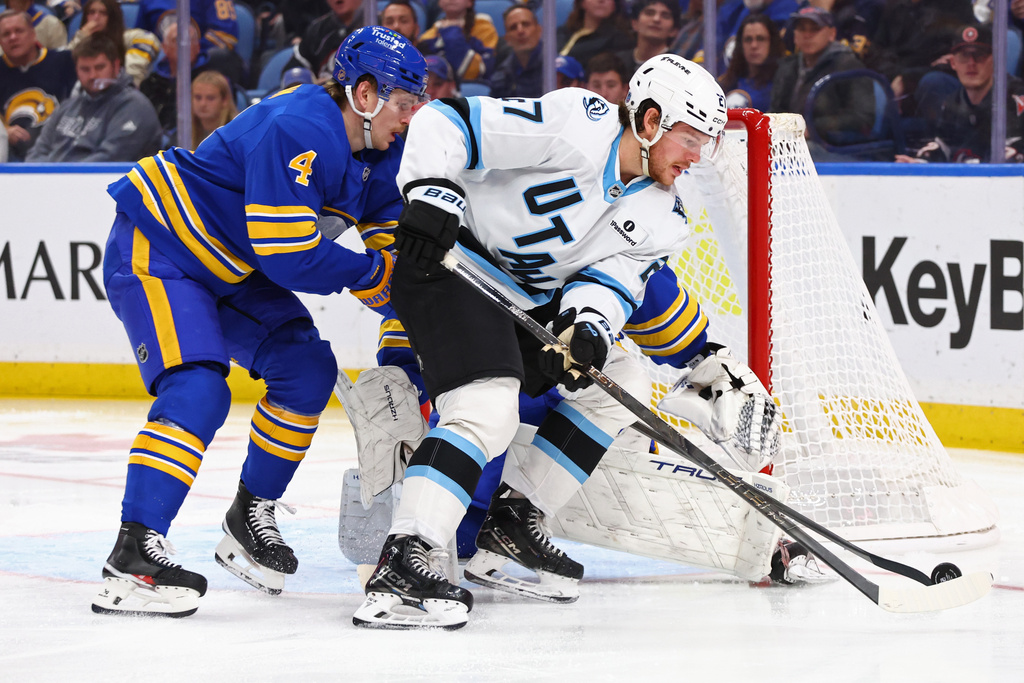 Buffalo Sabres defenseman Bowen Byram (4) pressures Utah Mammoth center Barrett Hayton (27) during the second period of an NHL hockey game Tuesday, Nov. 4, 2025, in Buffalo, N.Y. (AP Photo/Jeffrey T. Barnes)
