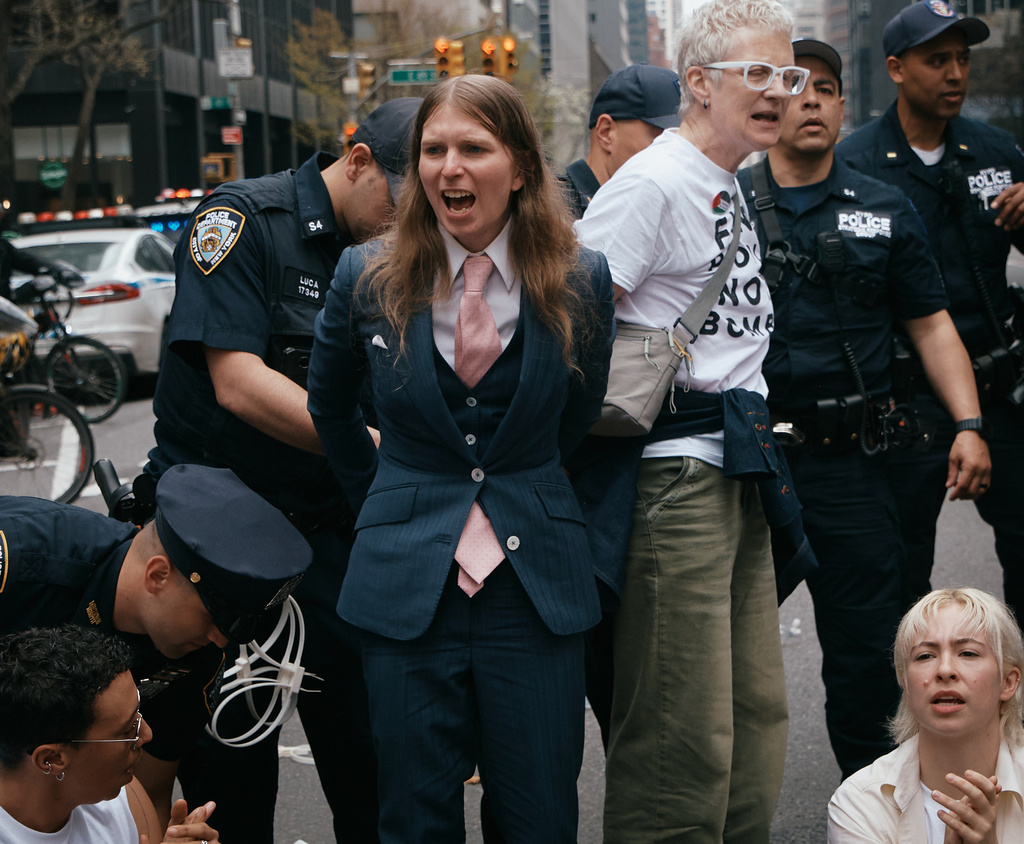 Chelsea Manning, center, is arrested by police as protesters with Jewish Voice for Peace block traffic during a demonstration outside the New York office of U.S. Sen. Chuck Schumer, calling for an end to the U.S.-Israel war with Iran and opposing U.S. weapons support on Monday, April 13, 2026, in New York. (AP Photo/Andres Kudacki)