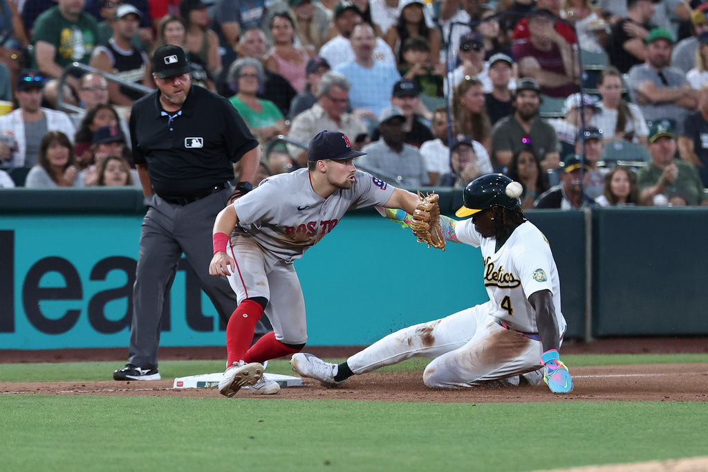 Boston Red Sox third baseman Caleb Durbin, left, attempts to get Athletics' Lawrence Butler (4) out during the sixth inning of a baseball game Thursday, July 30, 2026, in West Sacramento, Calif. (AP Photo/Sara Nevis)