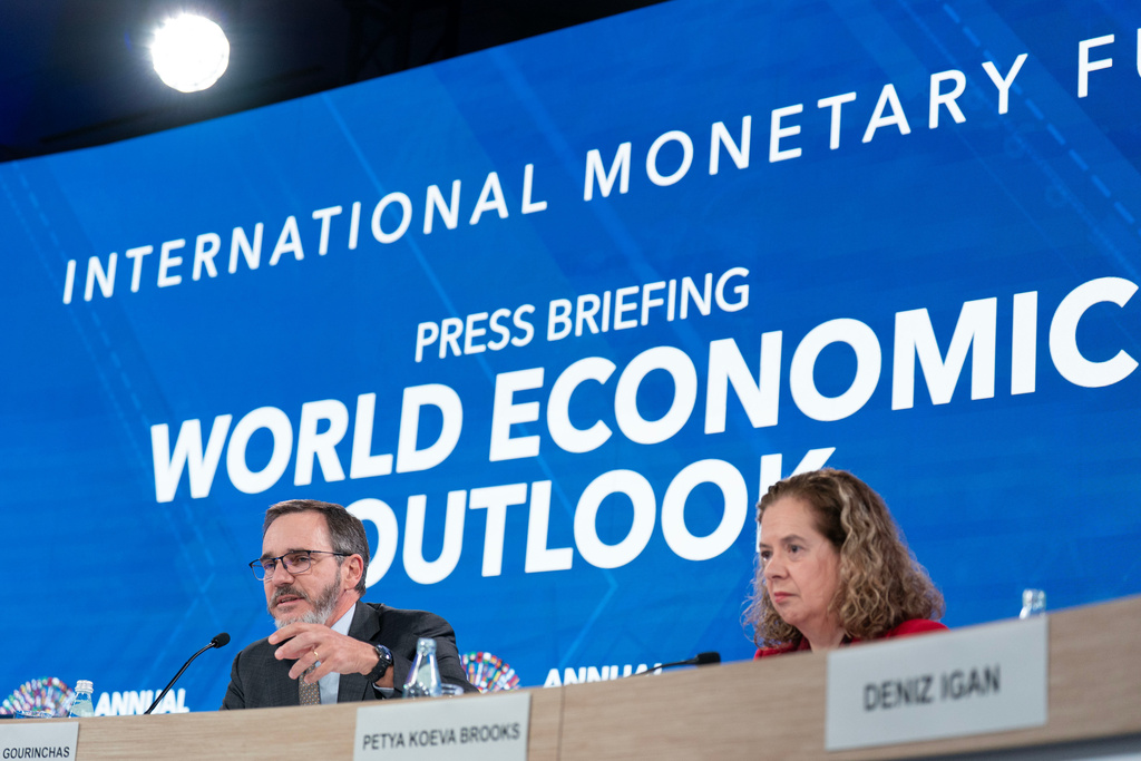 Economic Counsellor and Director, Research Department, IMF Pierre-Olivier Gourinchas, left, and Deputy Director, Research Department, IMF Petya Koeva-Brooks speak at a news conference during the World Bank/IMF Annual Meetings at the International Monetary Fund (IMF) headquarters in Washington, Tuesday, Oct. 14, 2025. (AP Photo/Jose Luis Magana)