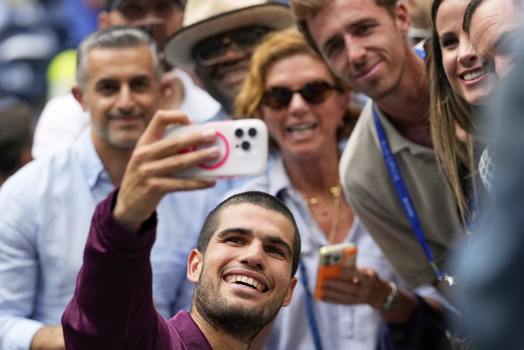 Carlos Alcaraz, of Spain, takes a seflie after defeating Novak Djokovic, of Serbia, during the men's singles semifinals of the U.S. Open tennis championships, Friday, Sept. 5, 2025, in New York. (AP Photo/Seth Wenig)