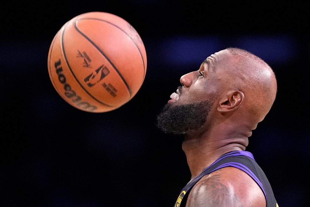 Los Angeles Lakers forward LeBron James watches the ball come down after he bounced it prior to tipoff of an NBA basketball game against the New Orleans Pelicans, Tuesday, March 3, 2026, in Los Angeles. (AP Photo/Mark J. Terrill)
