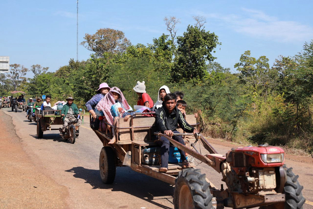 In this photo released by Agence Kampuchea Press (AKP), Cambodian villagers sit on tractors as they flee from the home in Preah Vihear province, Cambodia, Monday, Dec. 8, 2025. (AKP via AP)