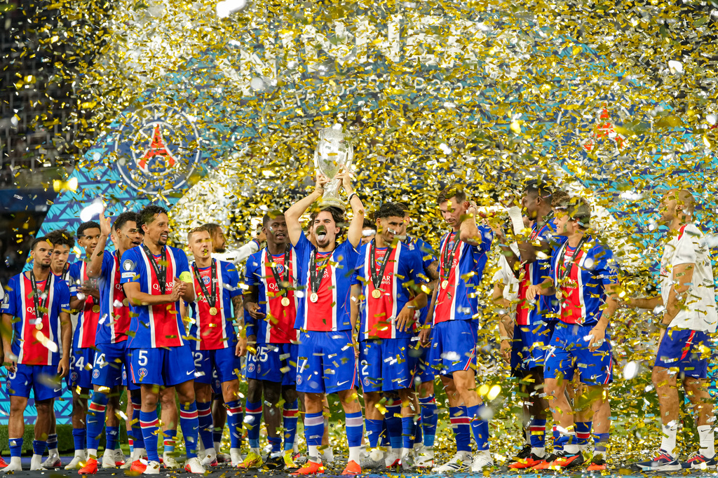 PSG's Vitinha lifts the trophy during celebrations at the end of the UEFA Super Cup soccer match between Paris Saint-Germain and Aston Villa in Salzburg, Austria, Wednesday, Aug.12, 2026. (AP Photo/Darko Bandic)