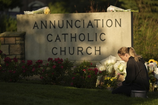 Ann Stovner kneels by a makeshift memorial at Annunciation Catholic Church after Wednesday's school shooting, Thursday, Aug. 28, 2025, in Minneapolis. (AP Photo/Abbie Parr) Ann Stovner kneels by a makeshift memorial at Annunciation Catholic Church after Wednesday's school shooting, Thursday, Aug. 28, 2025, in Minneapolis. (AP Photo/Abbie Parr)