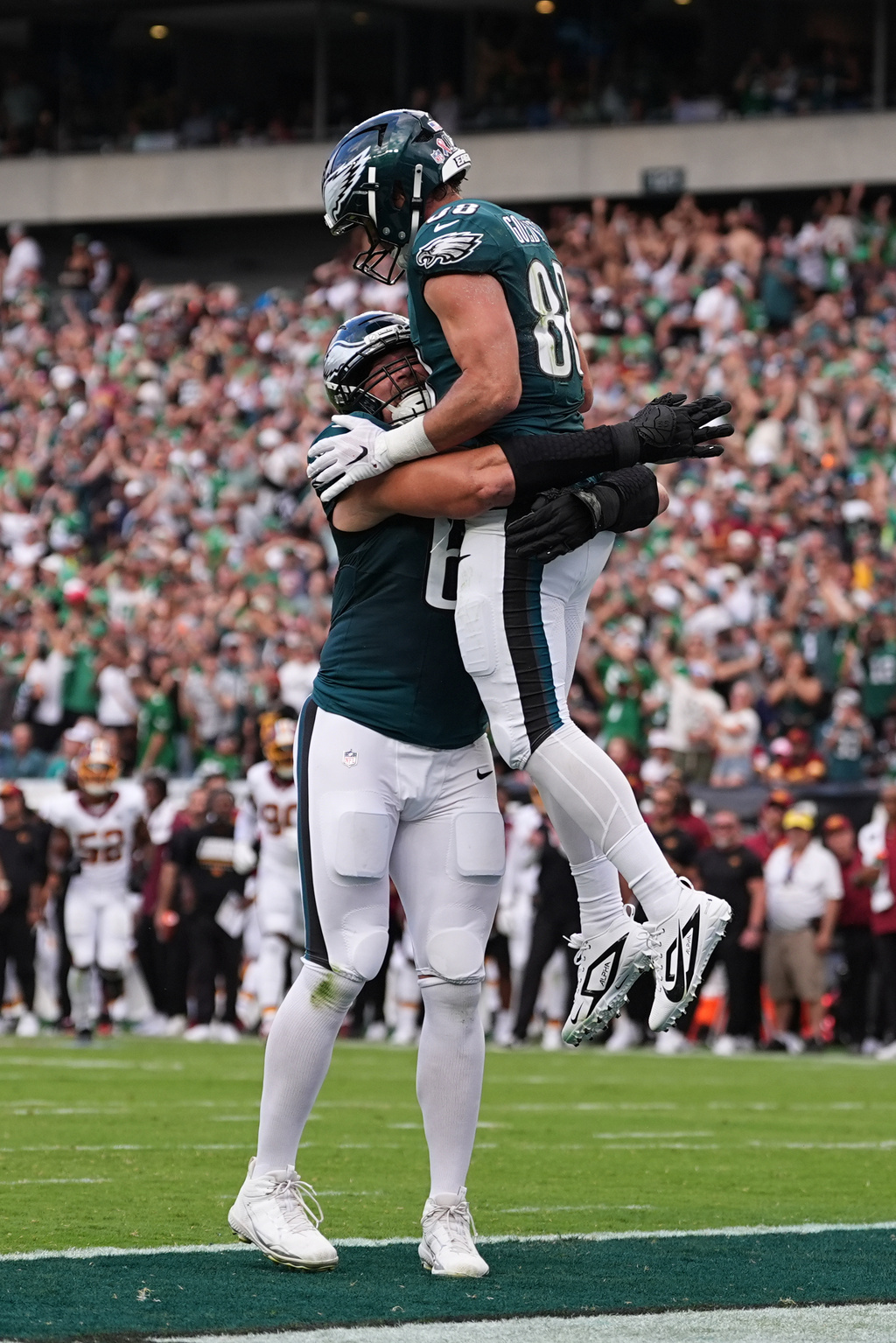 Philadelphia Eagles tight end Dallas Goedert (88) celebrates his touchdown catch with teammate Lane Johnson (65) during the first half of an NFL football game, Sunday, Sept. 13, 2026, in Philadelphia. (AP Photo/Matt Rourke)