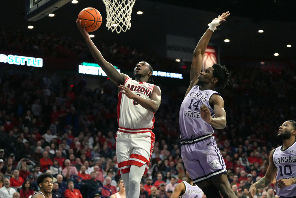 Arizona guard Jaden Bradley (0) drives past Kansas State guard Mobi Ikegwuruka during the second half of an NCAA college basketball game, Wednesday, Jan. 7, 2026, in Tucson, Ariz. (AP Photo/Rick Scuteri)