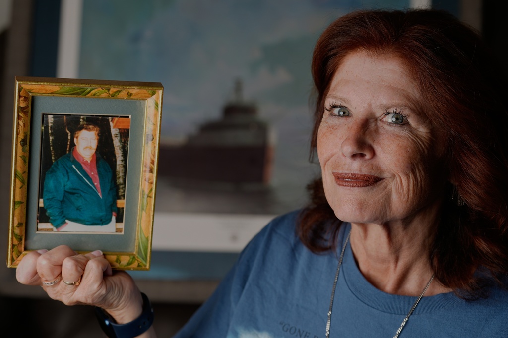Deb Felder holds up a picture of her father who died on the Edmund Fitzgerald Monday, Oct. 20, 2025, in her home in Nashotah, Wis. (AP Photo/Morry Gash)