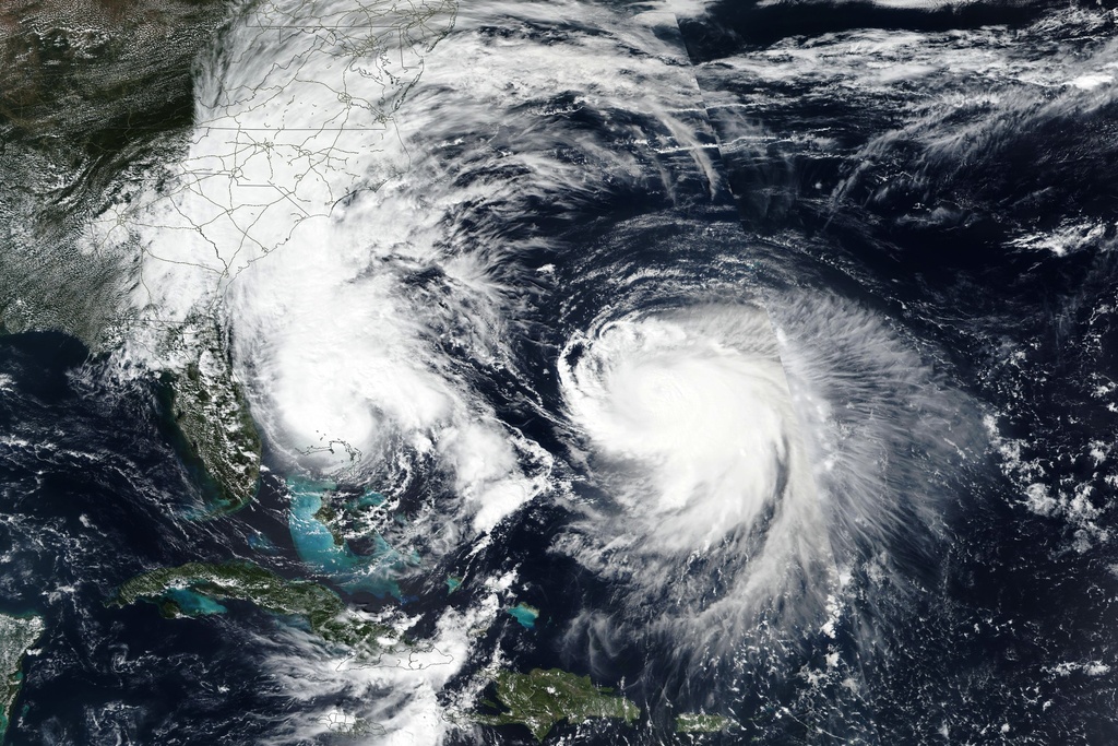 This Monday, Sept. 29, 2025, satellite image released by NASA shows Tropical Storm Imelda, left, and Hurricane Humberto in the Atlantic Ocean. (NASA Worldview, Earth Observing System Data and Information System (EOSDIS) via AP)