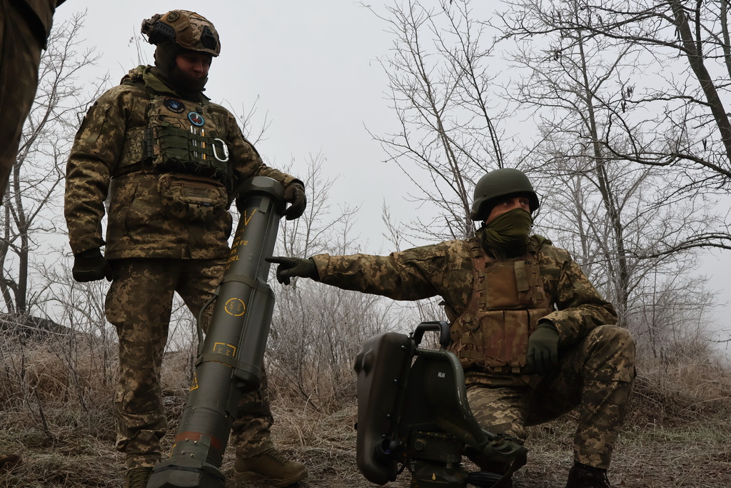 In this photo provided by Ukraine's 65th Mechanized Brigade press service, soldiers prepare a MILAN, a Franco-German anti-tank missile system, during a drill close to the frontline on the site of heavy battles with the Russian troops in the Zaporizhzhia region, Ukraine, Sunday, Jan. 4, 2026. (Andriy Andriyenko/Ukraine's 65th Mechanized Brigade via AP)