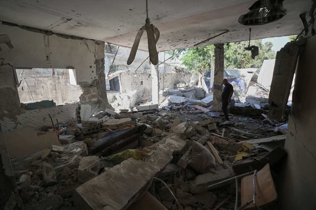 Palestinians inspect the damage at a police station that was hit by an Israeli airstrike in Gaza City, Wednesday, Aug. 19, 2026. (AP Photo/Jehad Alshrafi)