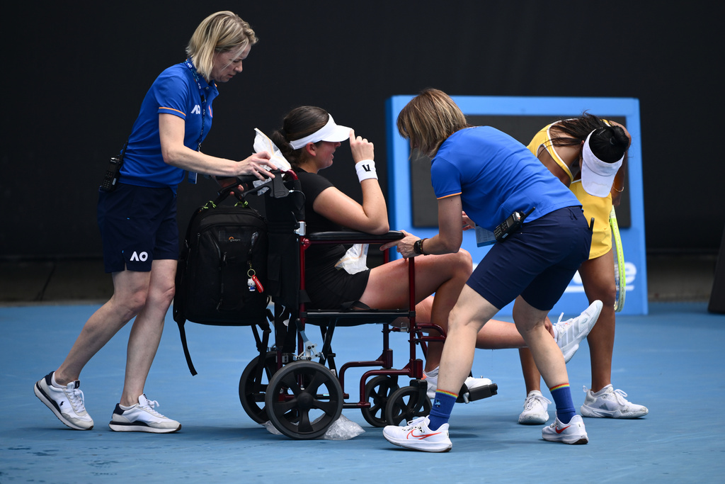 Marina Stakusic of Canada is taken from the court in a wheelchair after retiring in her first round match against Priscilla Hon, right, of Australia at the Australian Open tennis tournament in Melbourne, Australia, Monday, Jan. 19, 2026. (Joel Carrett/AAP Image via AP)