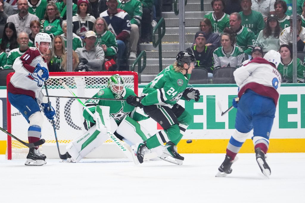 Colorado Avalanche defenseman Cale Makar, right, scores on a power play shot against Dallas Stars goaltender Jake Oettinger (29) during the first period of an NHL hockey game Friday, March 6, 2026, in Dallas. (AP Photo/Julio Cortez)