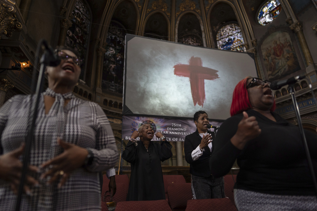 The New Mount Pilgrim Missionary Baptist Church choir, including Cynthia Webb, left, Tonia Johnson, second left, and Jennifer Hatch, right, sings during a service Sunday, Sept. 7, 2025, in Chicago. (AP Photo/Carolyn Kaster)