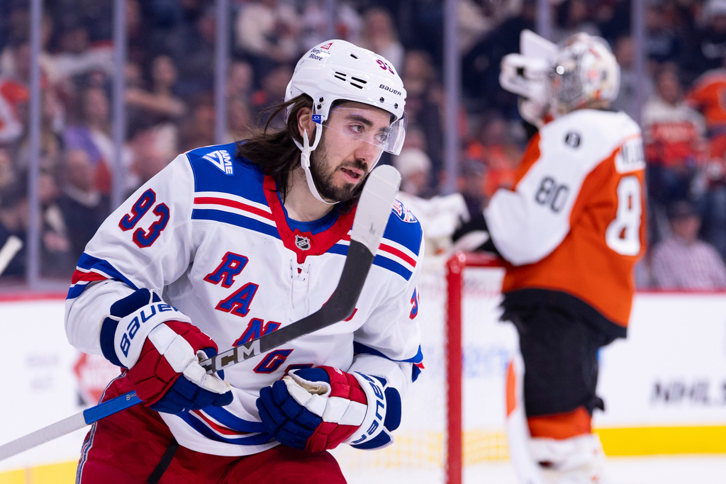 New York Rangers center Mika Zibanejad, left, looks on after scoring a goal against Philadelphia Flyers goalie Dan Vladar, right during the first period of an NHL hockey game, Monday, March 9, 2026, in Philadelphia. (AP Photo/Chris Szagola)