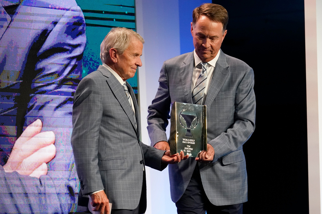 FILE - Former PGA Tour commissioner Tim Finchem, left, is inducted into the World Golf Hall of Fame by Davis Love IIII, March 9, 2022, in Ponte Vedra Beach, Fla. (AP Photo/Gerald Herbert, File)