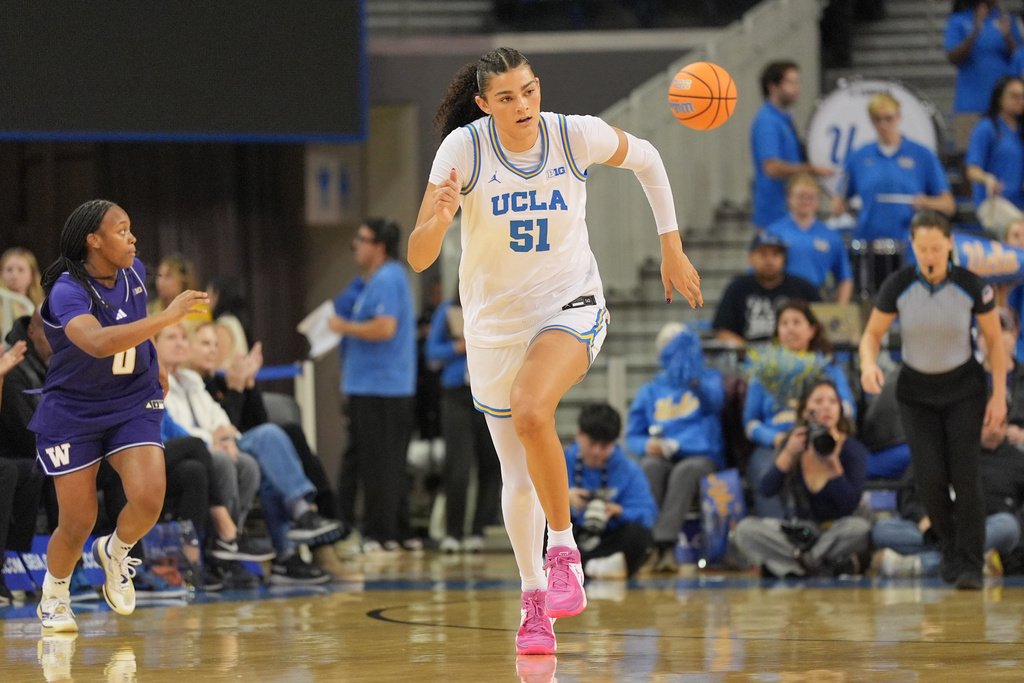 UCLA center Lauren Betts (51) jogs up the court after making a basket during the first half of an NCAA women's college basketball game against Washington in Los Angeles, Thursday, Feb. 19, 2026. (AP Photo/Jae C. Hong)