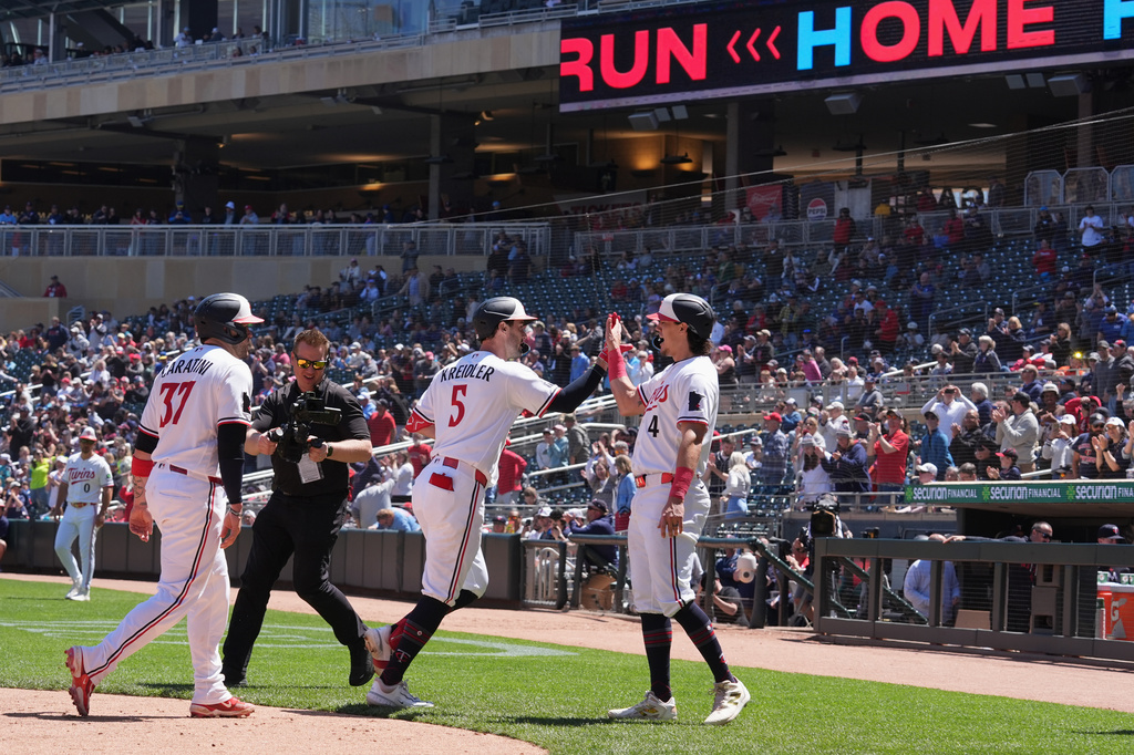 Minnesota Twins' Ryan Kreidler (5) celebrates with Tristan Gray (4) after hitting a three-run home run during the fourth inning of a baseball game against the Houston Astros, Wednesday, May 20, 2026, in Minneapolis. (AP Photo/Abbie Parr)