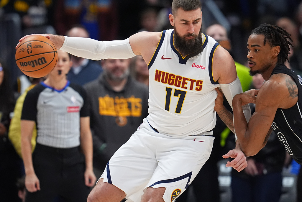 Denver Nuggets center Jonas Valančiūnas (17) drives to the net as Brooklyn Nets center Nic Claxton, right, defends in the first half of an NBA basketball game Thursday, Jan. 29, 2026, in Denver. (AP Photo/David Zalubowski)