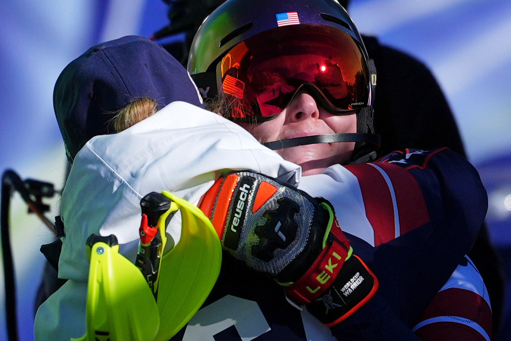 United States' Mikaela Shiffrin is hugged by her coach Karin Harjo after winning an alpine ski, women's slalom race, at the 2026 Winter Olympics, in Cortina d'Ampezzo, Italy, Wednesday, Feb. 18, 2026. (AP Photo/Jacquelyn Martin)