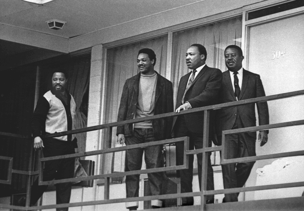 FILE - Rev. Martin Luther King Jr., second from right, stands with Hosea Williams, left, Jesse Jackson, second from left, and Ralph Abernathy, right, on the balcony of the Lorraine Motel in Memphis, Tenn., a day before he was assassinated at approximately the same place, April 3, 1968. (AP Photo/Charles Kelly, File)