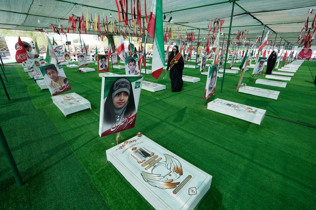 A woman walks at the graveyard of the school children who were killed after their school was a hit by a strike on Feb. 28, in town of Minab in southern Iran, Saturday, Sept. 5, 2026. (AP Photo/Vahid Salemi)