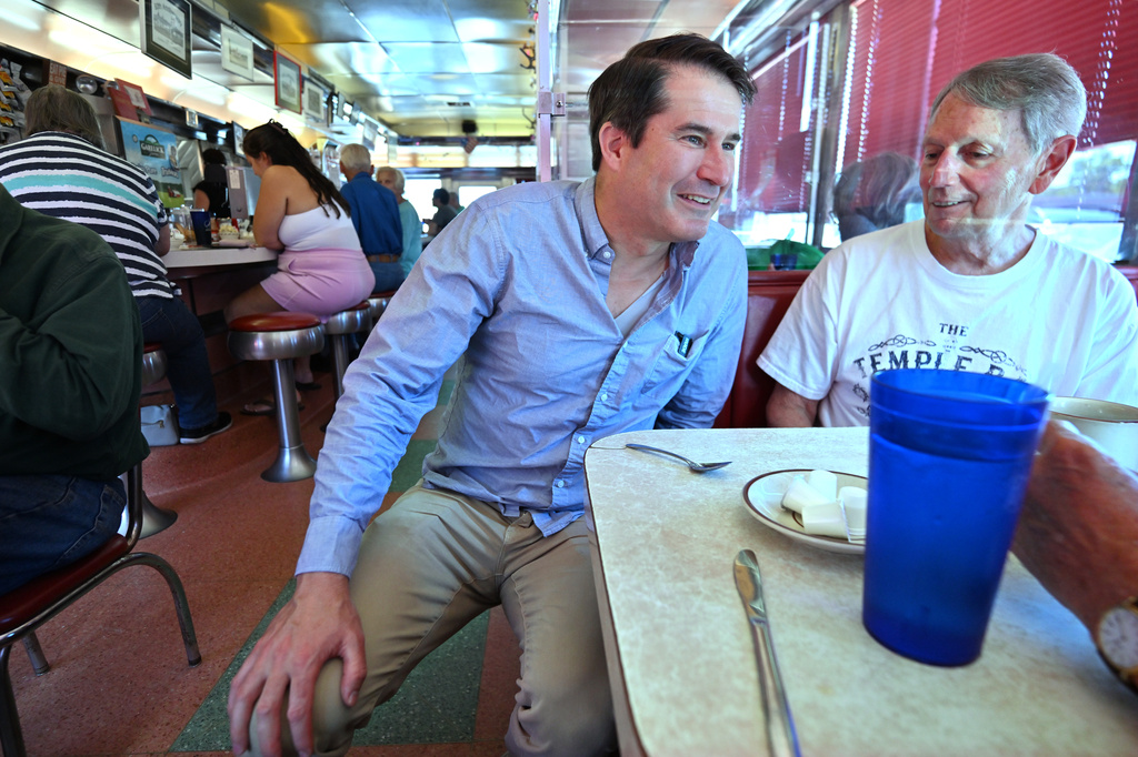 U.S. Rep. Seth Moulton, D-Mass., who is challenging Sen. Ed Markey, D-Mass. in the Sept. 1, 2026 primary, speaks to Rich Giannino of Essex, Mass., during a campaign stop at the Agawam Diner Saturday, Aug. 29, 2026, in Rowley, Mass. (AP Photo/Josh Reynolds)
