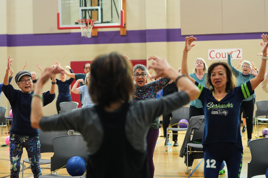 From left, Ann Kashiwa, Alma Alvarez-Smith and Pilar Madayag follow instructor Bengie Santos, 72, as she leads an exercise class for older adults at the Dale Turner Family YMCA, April 30, 2026, in Shoreline, Wash. (AP Photo/Lindsey Wasson)